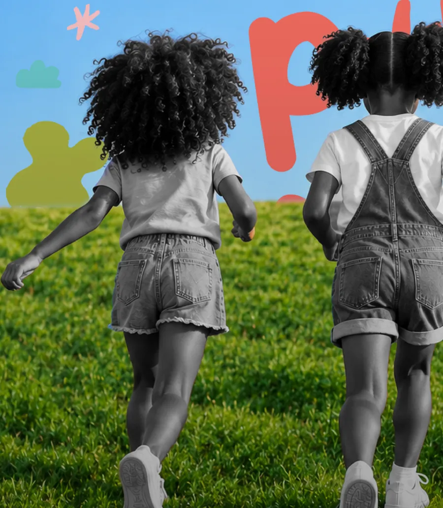 Kids running up a grassy hill
